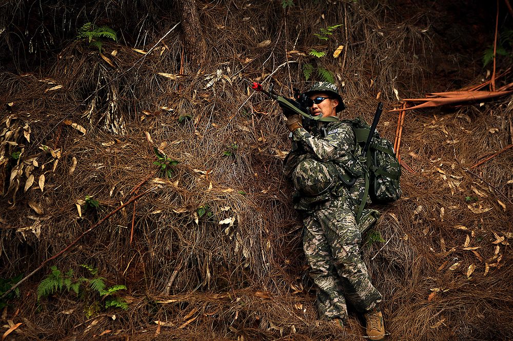A Republic of Korea marine with 1st Company, 1st Battalion, 3rd Regiment, holds security during a simulated assault of radio…