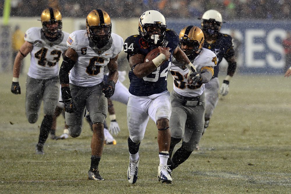 Noah Copeland, center, a fullback with the U.S. Naval Academy football team, breaks for the Navy?s first touchdown during…