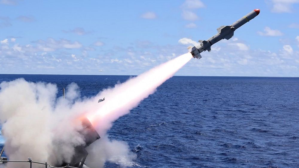 The Ticonderoga-class guided-missile cruiser USS Antietam (CG 54) launches a harpoon surface-to-surface missile alongside…