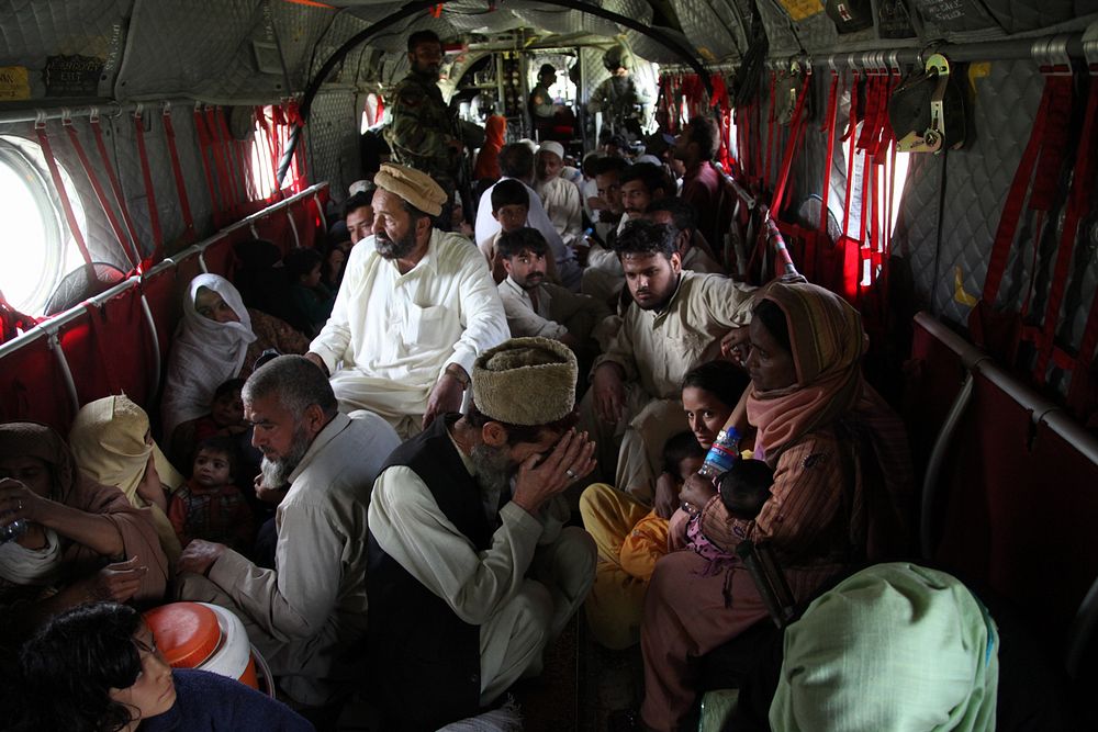 Pakistanis sit on the floor of a U.S. Army CH-47 Chinook helicopter during an evacuation mission from Khyber Pakhtunkhwa…