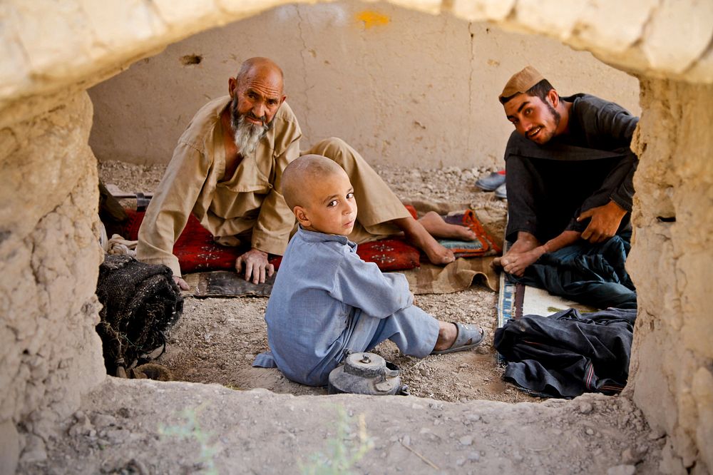 Afghan villagers rest inside their compound as U.S. Special Operations forces (SOF) conduct a combat reconnaissance patrol…