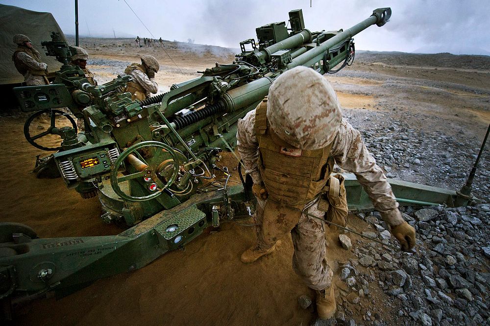U.S. Marine Corps Lance Cpl. Bradley Washington, with Company Echo, 1st Battalion, 12th Marine Regiment, fires a 155 mm…
