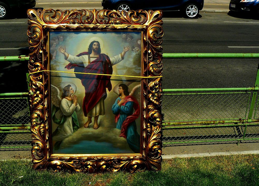 Framed Christ painting on street. View public domain image source here