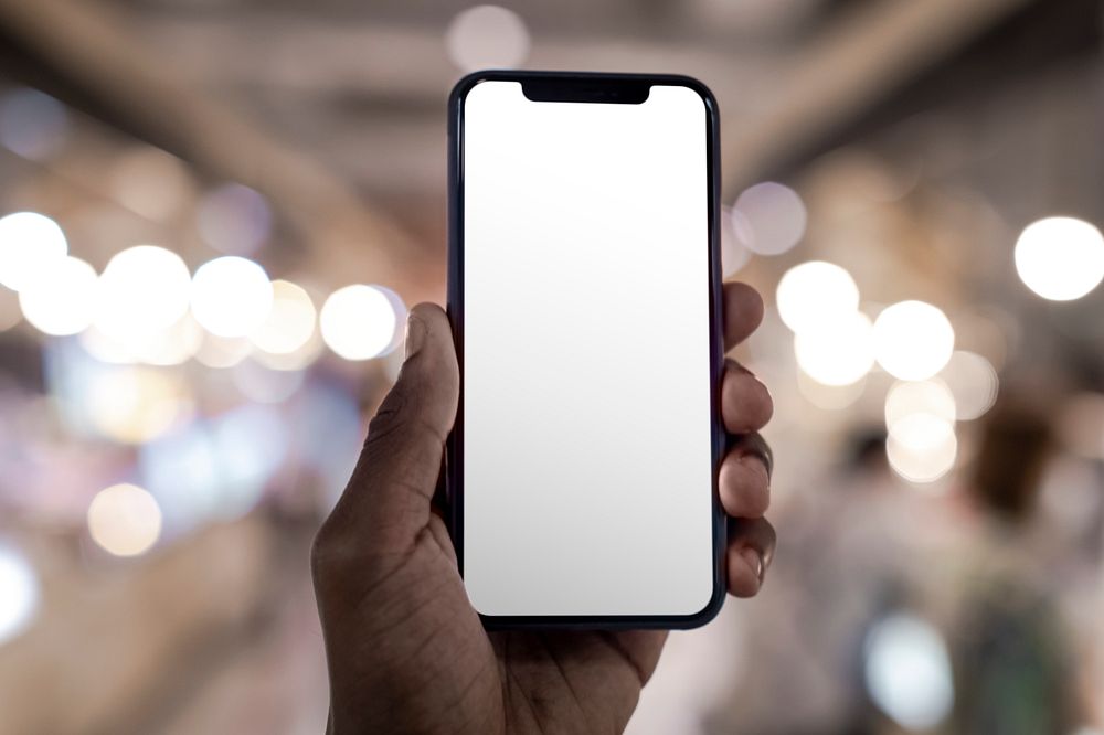 Smartphone screen mockup with bokeh night lights in the background psd