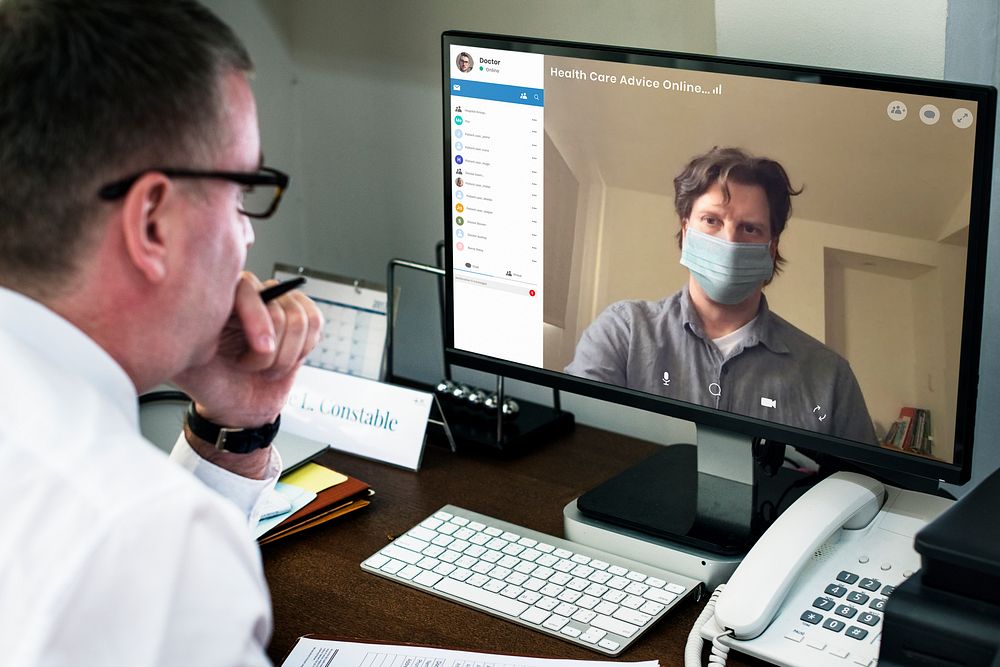 Colleagues having a video conference on a laptop mockup during the coronavirus pandemic