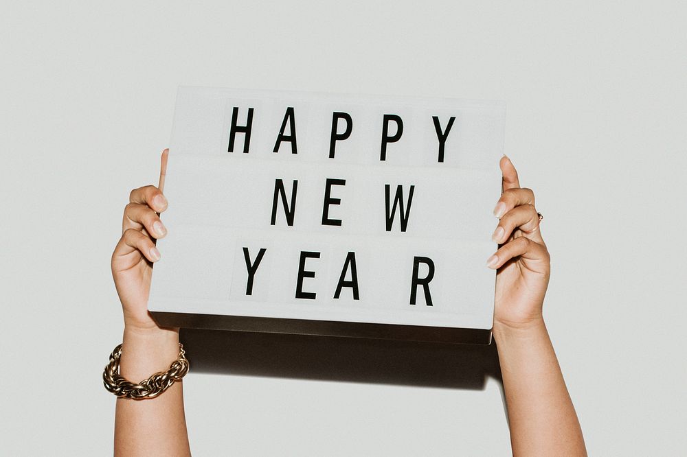 Hands holding a happy new year sign mockup