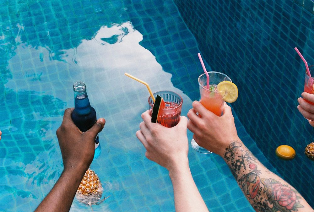 A diverse group of friends enjoying summer time with beverages in hands