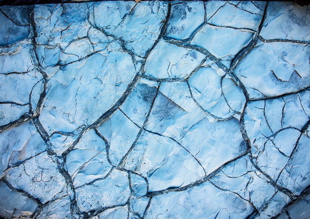 Blue background, cracked rock texture