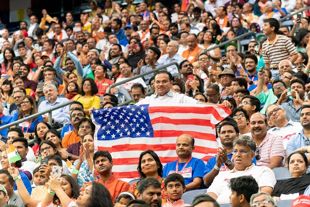 Howdy, Modi! Audience members in a crowd of more than 50,000 people hold up flags and banners as they cheer President Donald…