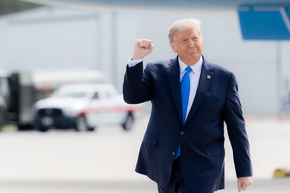 President Donald J. Trump gestures with a fist pump as he walks across the tarmac upon his arrival Thursday, Oct. 15, 2020…