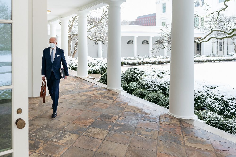 A blanket of snow covers the Rose Garden of the White House Monday, Feb. 1, 2021, as President Joe Biden walks along the…