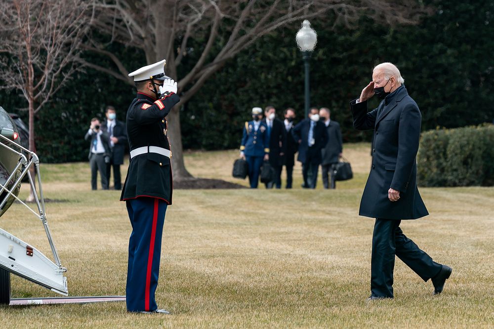 President Joe Biden salutes a U.S. Marine as he prepares to board Marine One on the South Lawn of the White House Friday…