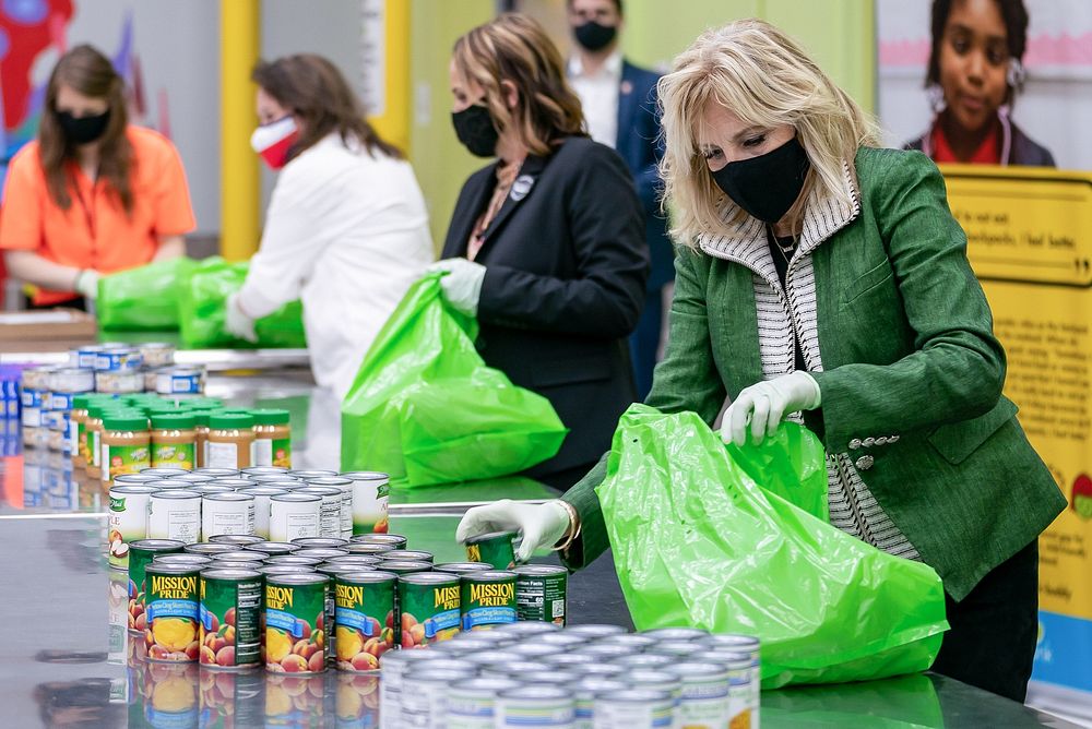 First Lady Jill Biden packs canned goods into bags for children in the Buddy Backpack program Friday, Feb. 26, 2021, at the…