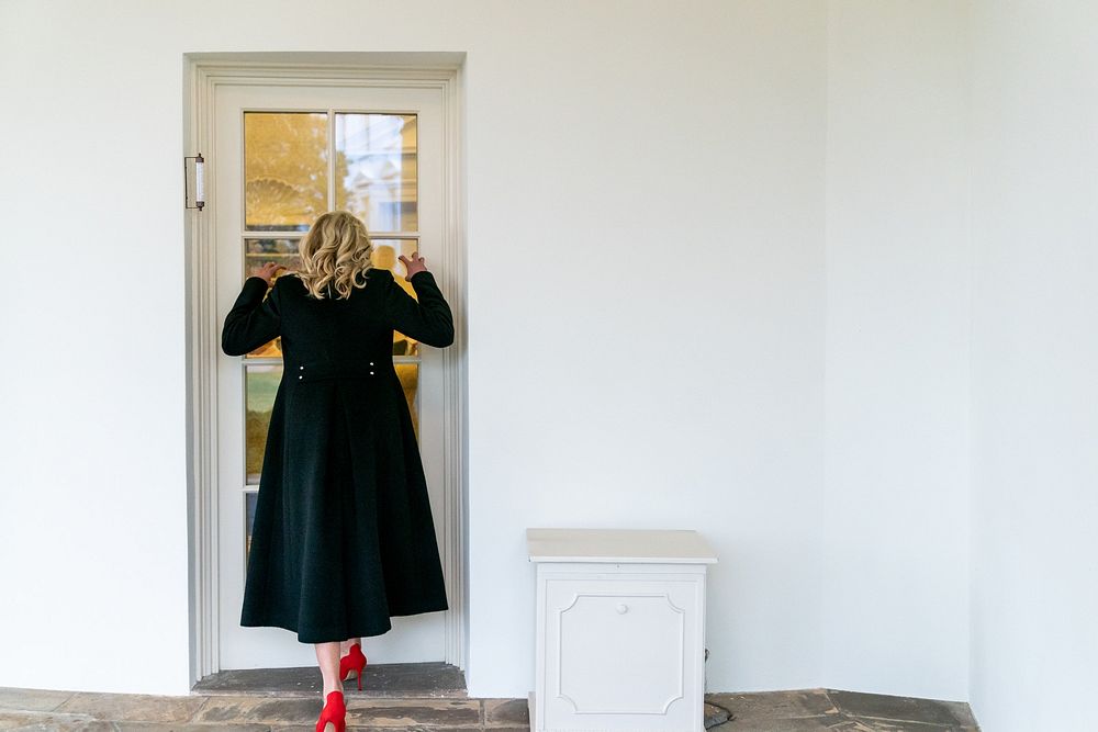 First Lady Jill Biden waits at the window outside the Oval Office of the White House Wednesday, March 24, 2021, to scare…