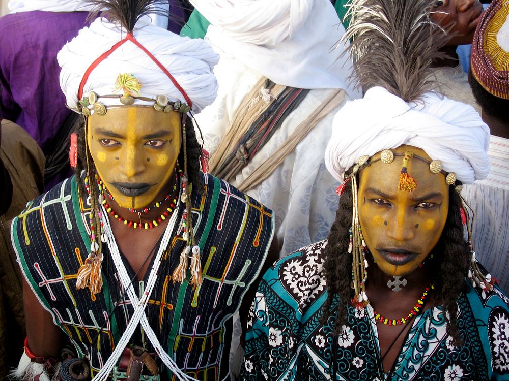 Locals dressed and face-painted for a ceremony. Original public domain image from Flickr