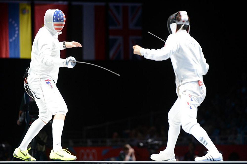 U.S. Air Force Capt. Seth Kelsey, left, competes in the Olympic men's epee individual bronze medal fencing match against…