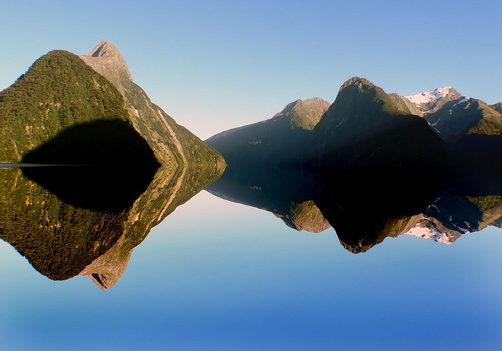 Reflecting mountain on water. Milford Sound, New Zealand. Original public domain image from Flickr