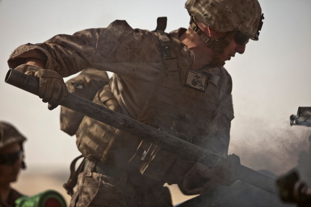 A U.S. Marine with Bravo Battery, 1st Battalion, 11th Marine Regiment, 15th Marine Expeditionary Unit swabs the breech of an…