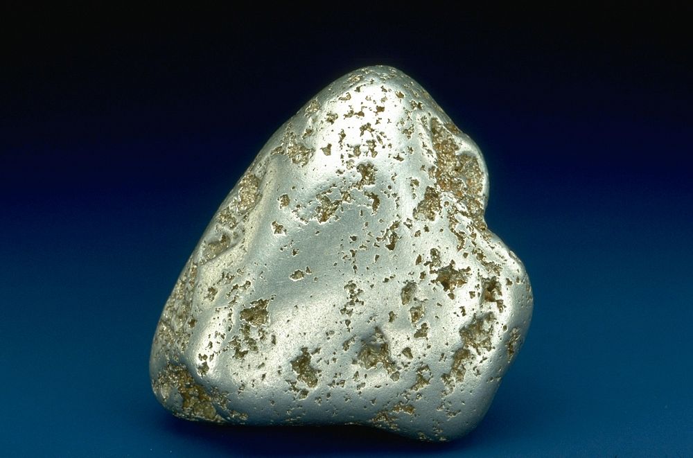 Platinum ore on blue background. Original public domain image from Flickr