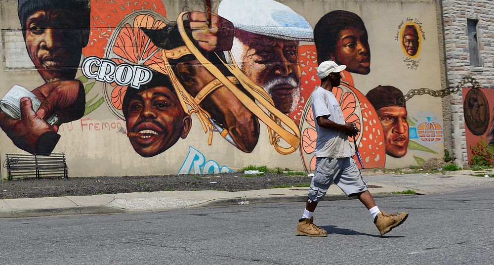 A man walks across the street near the Arabers stable in Baltimore, MD., June 18, 2014. Street Arabers have been vending…