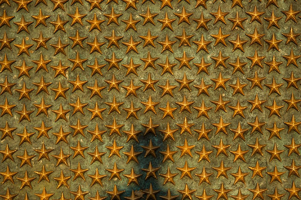 A shadow appears on the wall of stars at the National World War II Memorial, June 20, 2014 in Washington D.C. The World War…