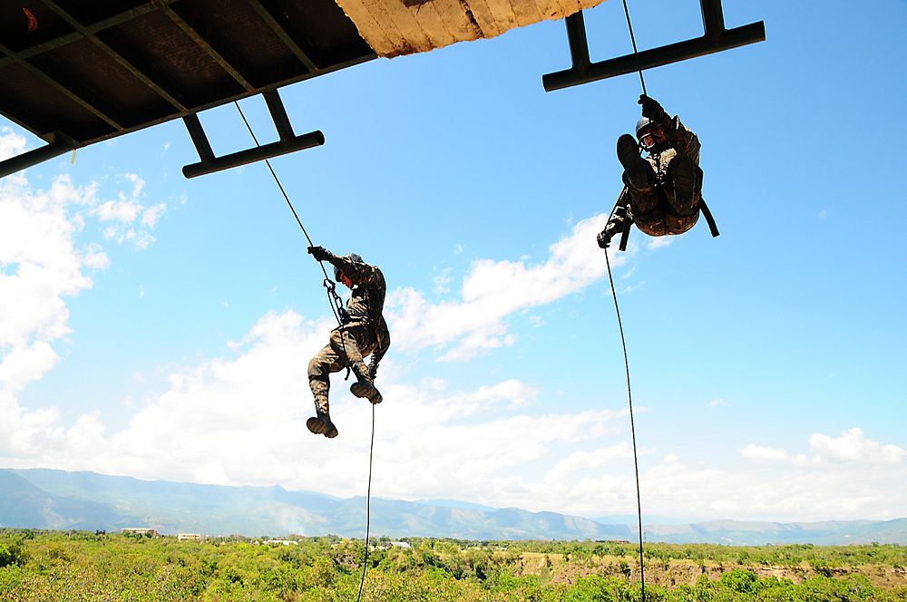 Two Guatemalan soldiers rappel down a 30-foot tower during a stress event at Fort Tolemaida, Colombia, July 28, 2014, as…