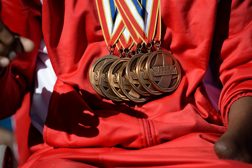 Gold medals shine on the chest of Marine Corps team Sgt. Anthony McDaniel Jr. during a Air Force against Navy football game…
