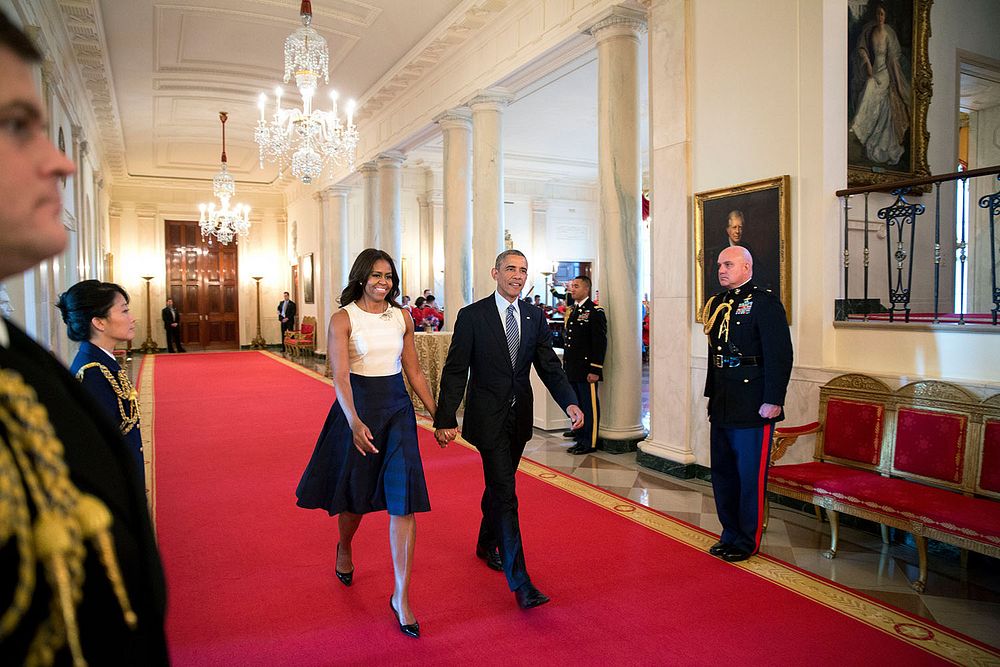 President Barack Obama and First Lady Michelle Obama walk down the Cross Hall to the Presidential Medal of Freedom ceremony…