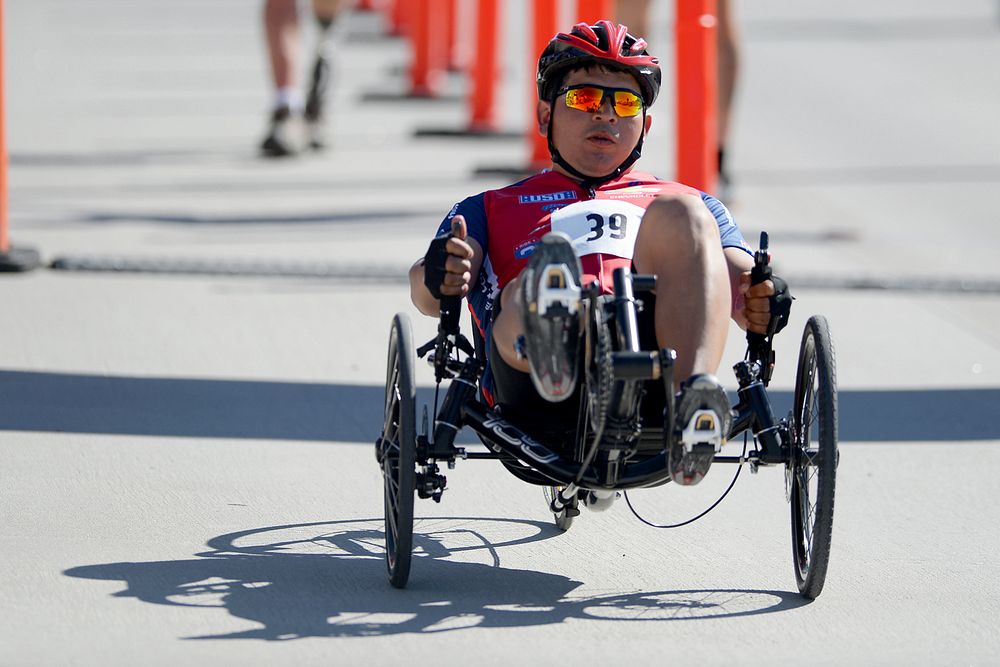 Army Chief Warrant Officer Timothy Sifuentes begins his victory ride in the men’s recumbent bicycle division during the Army…