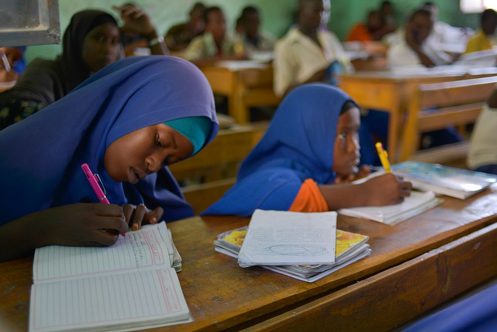 A student takes down notes at Al-Jaziira Primary School.