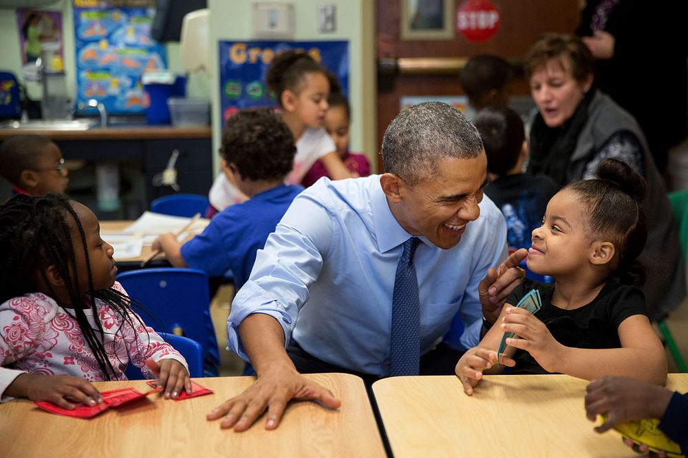 President Barack Obama gestures as he talks with Akira Cooper at the Community Children's Center, one of the nation's oldest…