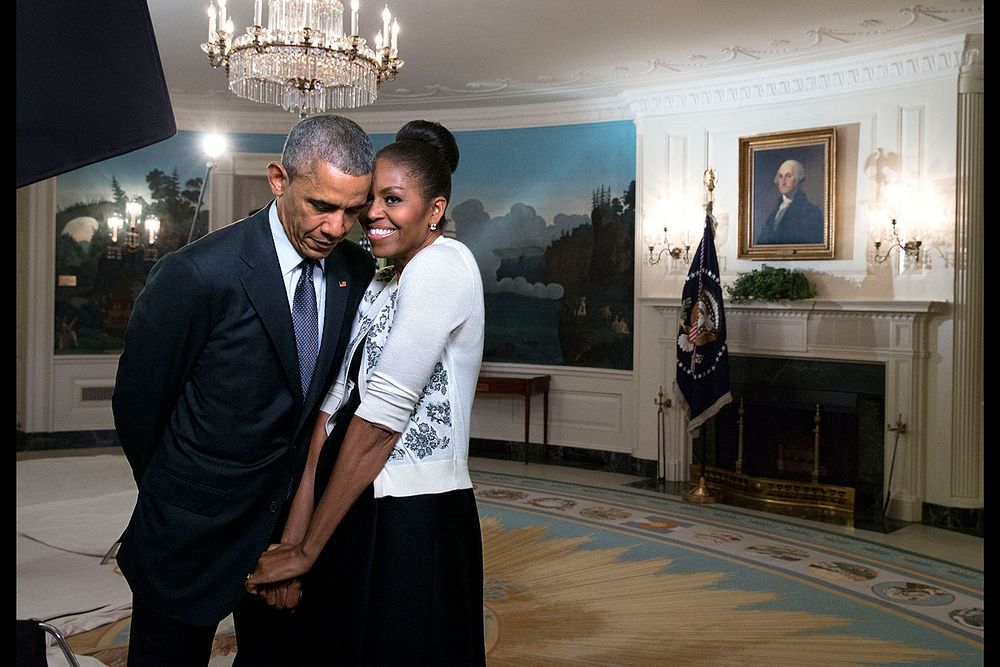 First Lady Michelle Obama snuggles against President Barack Obama before a videotaping for the 2015 World Expo, in the…