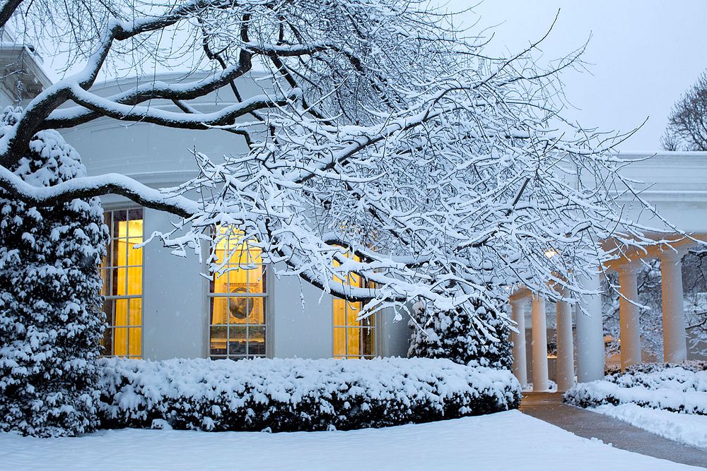 Lights from the Oval Office are seen from the snow-covered South Grounds of the White House, March 5, 2015.