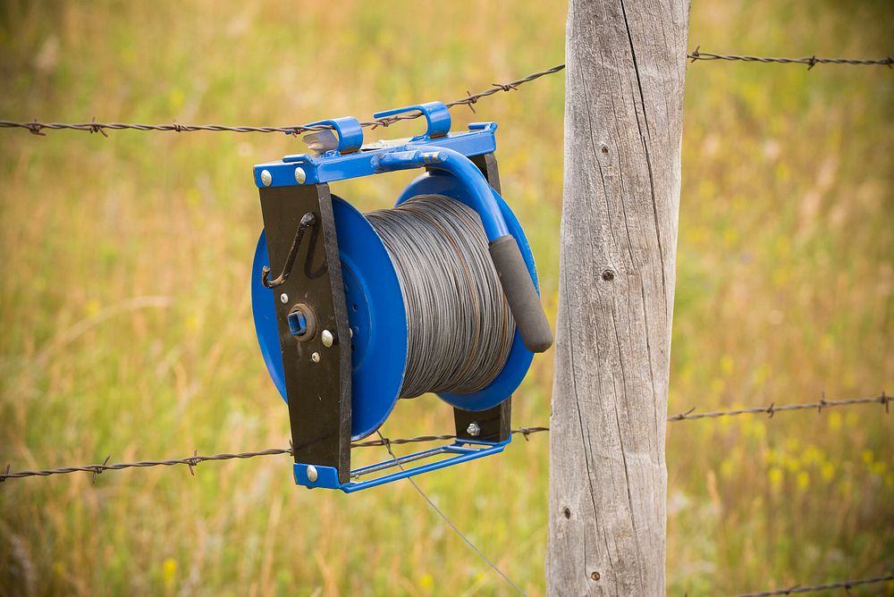 Electric fence wire dispenser on the Coulter Family Ranch in Garfield County. June 2017. Original public domain image from…