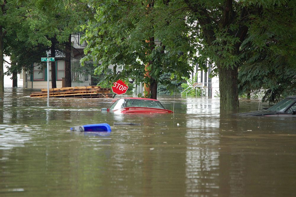 Flooded street in Cedar Rapids, IA near 13th Ave. and J Street, Cedar Rapids, IA. (photography: Don Becker, USGS). Original…