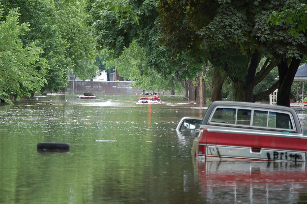 Flooded street near 12th Ave and M Street, Cedar Rapids, IA (photography: Don Becker, USGS). Original public domain image…
