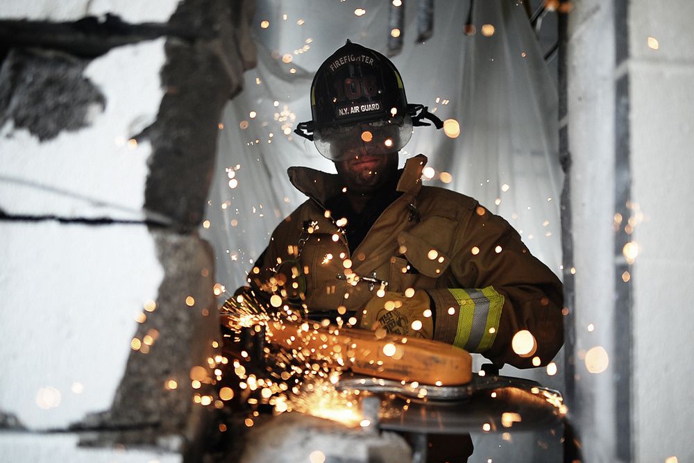 WESTHAMPTON BEACH, NY - Staff Sergeant Daniel Glenn, a firefighter with the 106th Rescue Wing, operates a powered saw in…