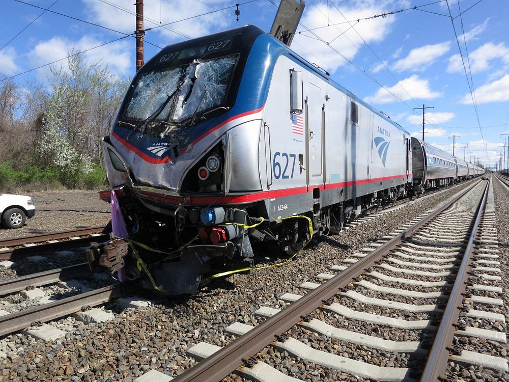 Passenger train struck a roadway maintenance machine, Chester, PA, 4/3/2016. Damage to Amtrak passenger train 89. Original…