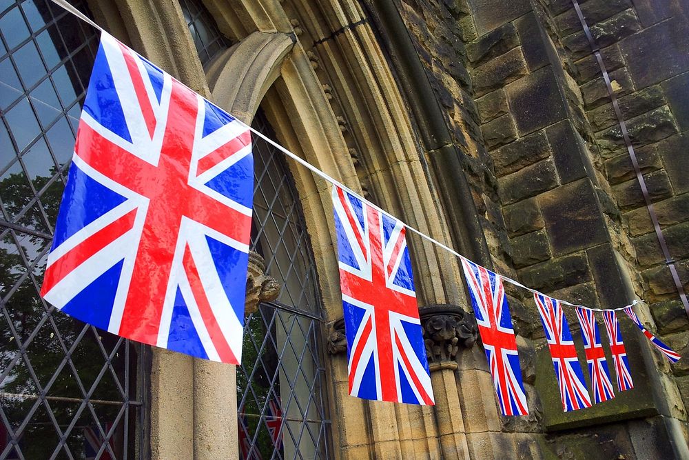 UK flag hanging on building. Free public domain CC0 photo.