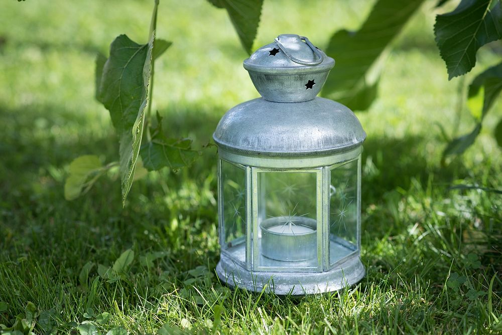 Silver lantern on grass. Free public domain CC0 photo.