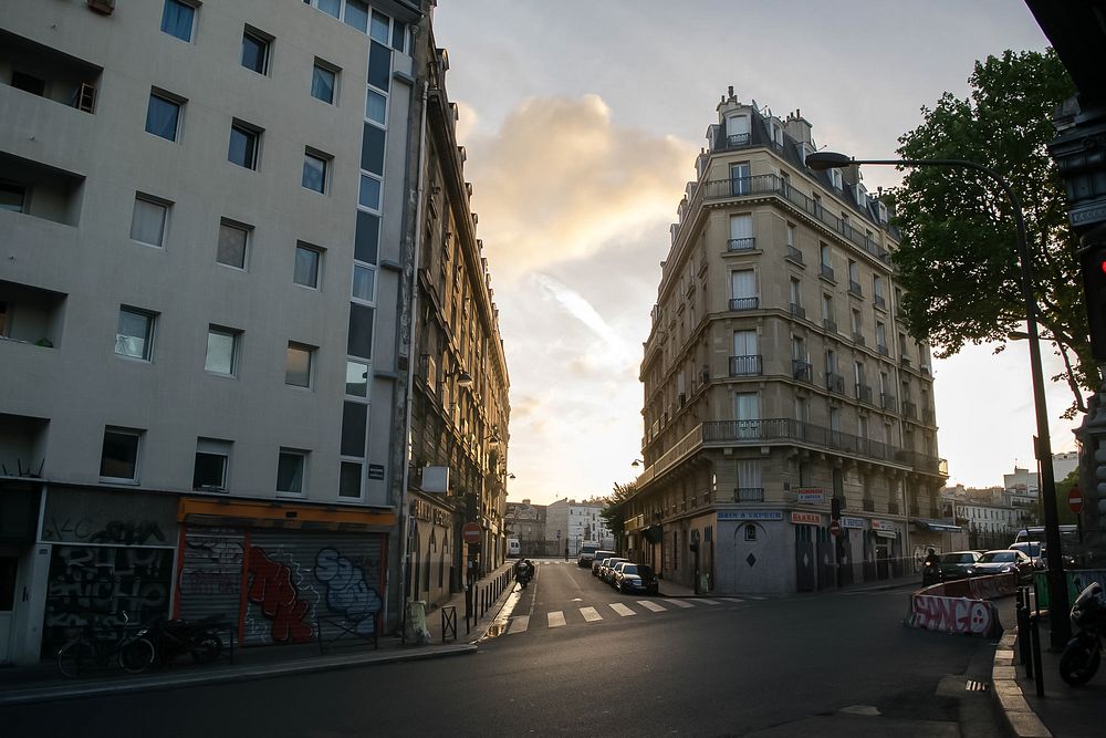 Low angle view of Paris street with parked cars and apartment buildings
