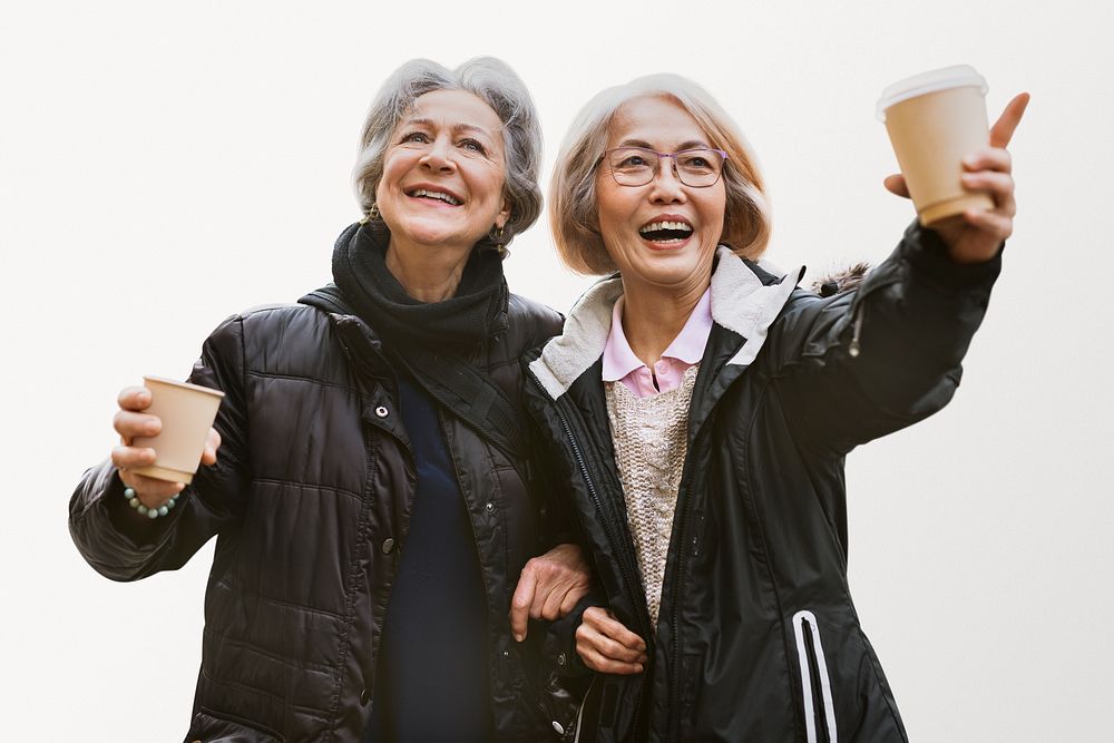Happy retired women drinking coffee on the go