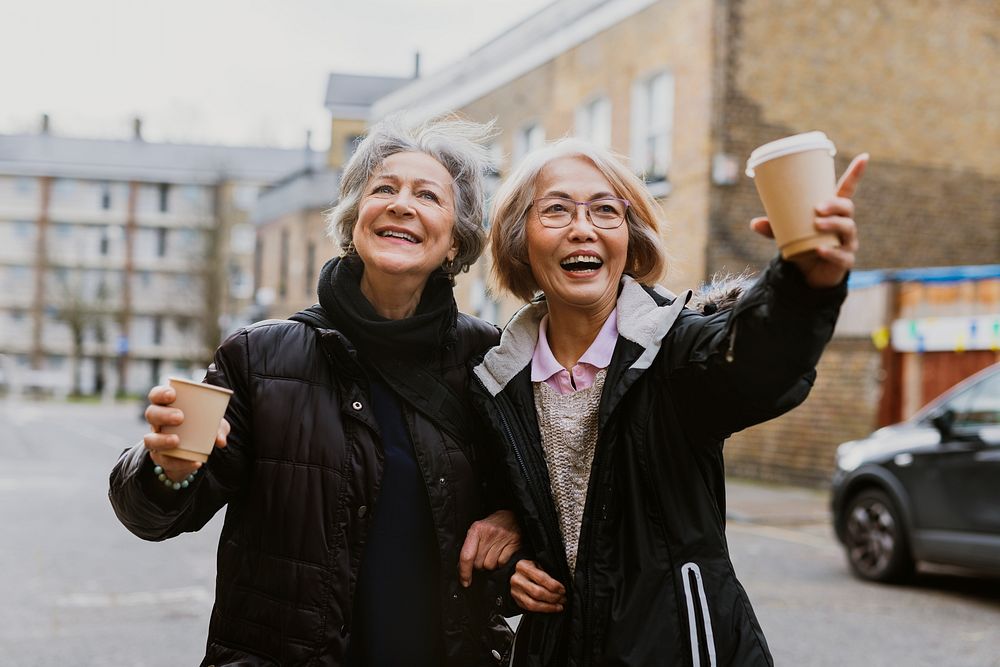 Friends drinking coffee from paper cups 