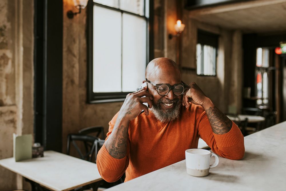 African American man on the phone at a coffee shop
