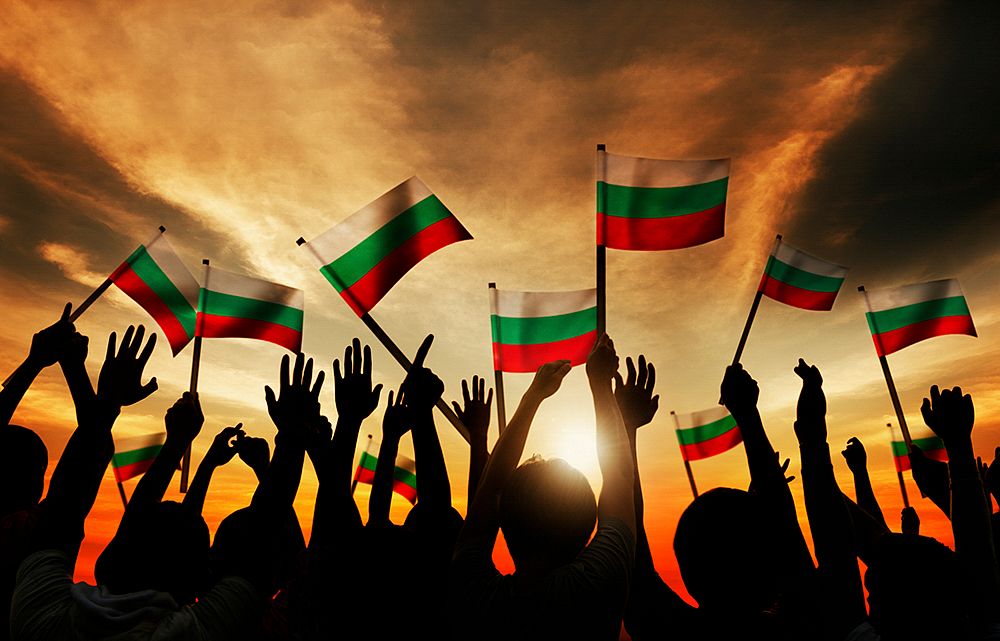 Silhouettes of People Holding Flag of Bulgaria