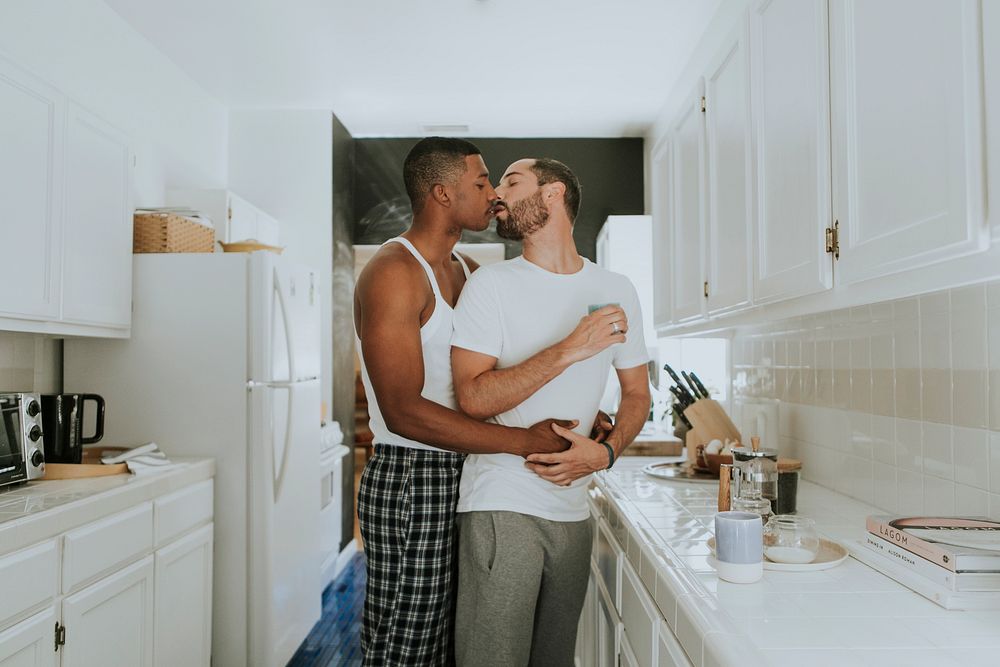 Gay couple kissing in the kitchen