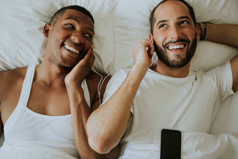 Couple listening to music in bed