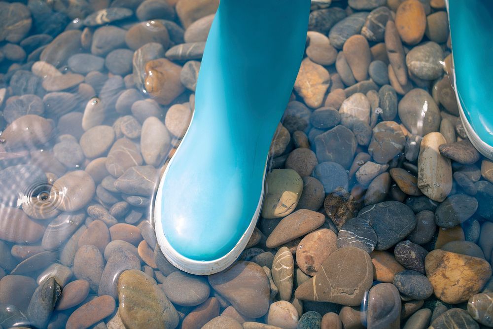 Close up of a child's blue rubber boot