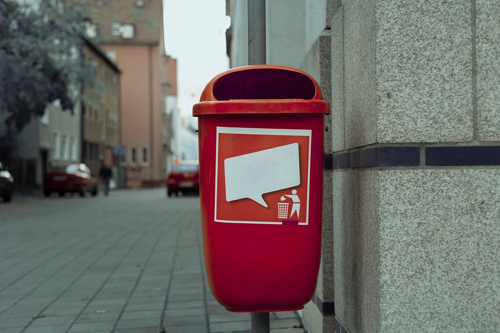 Red trash can on the street