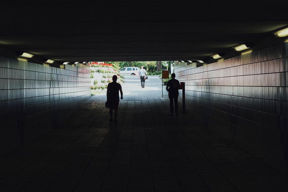 People walking through a tunnel